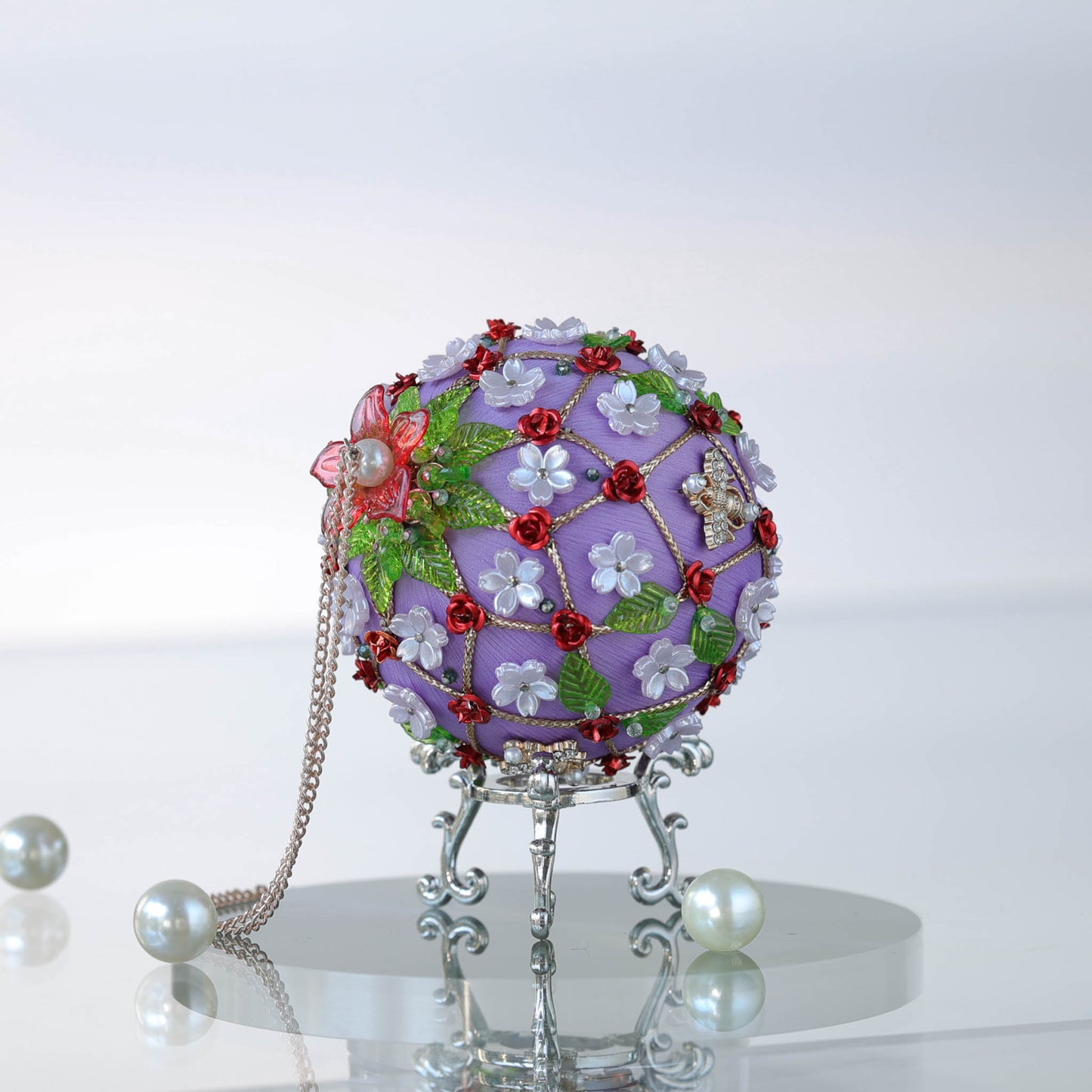 A side of a handmade push pin ornament with green acrylic leaf charms, white flowers, and a rose gold cording by Whim5seasons.