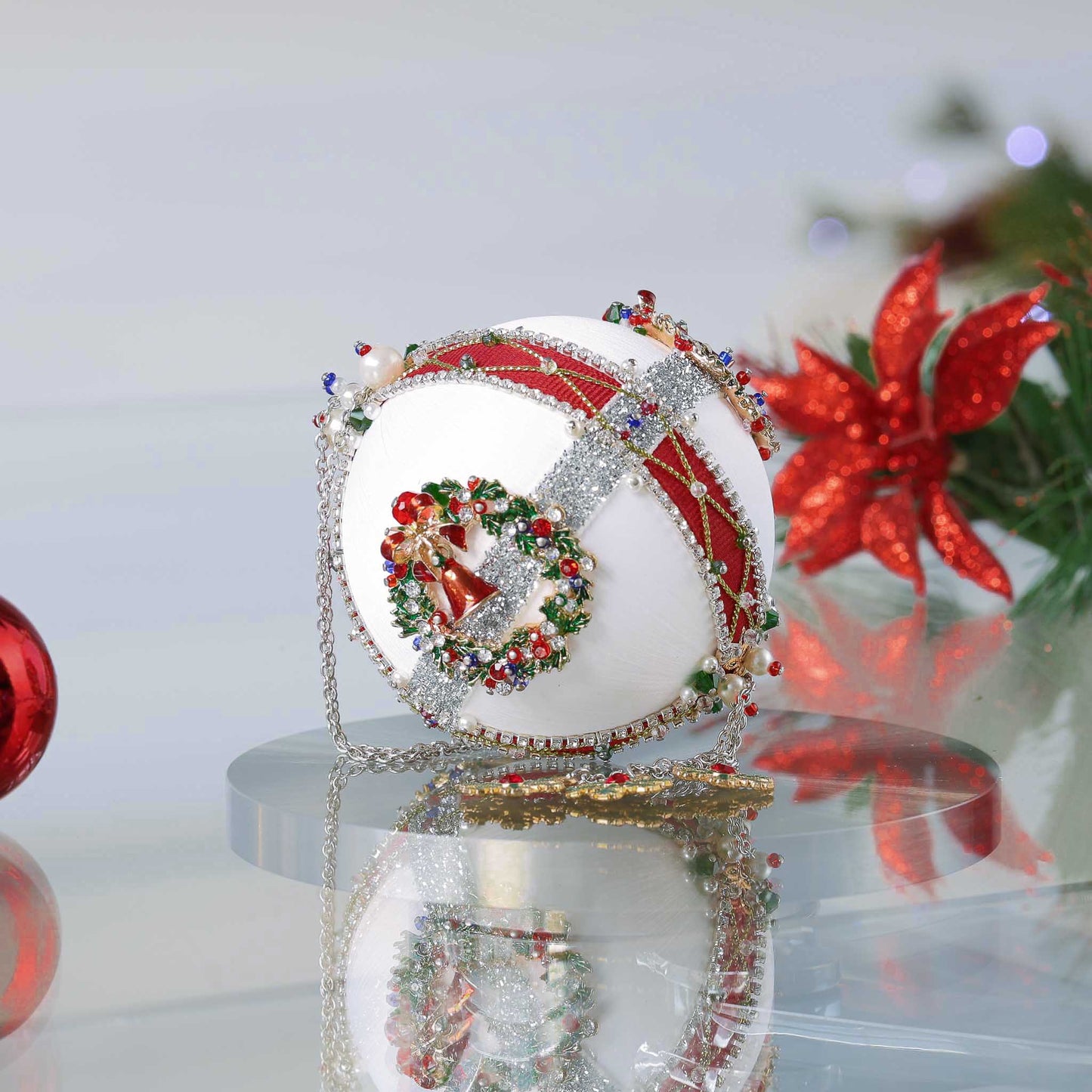 Sequin & beaded handmade from a push pin kit Christmas ball with festive design on a reflective surface by Whim5seasons.
