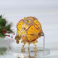 Load image into Gallery viewer, A side view of a handmade yellow satin  push pin ornament with gemstones featuring bead tassel and gold chains with holiday branch in the background by Whim5seasons. (Light Yellow)
