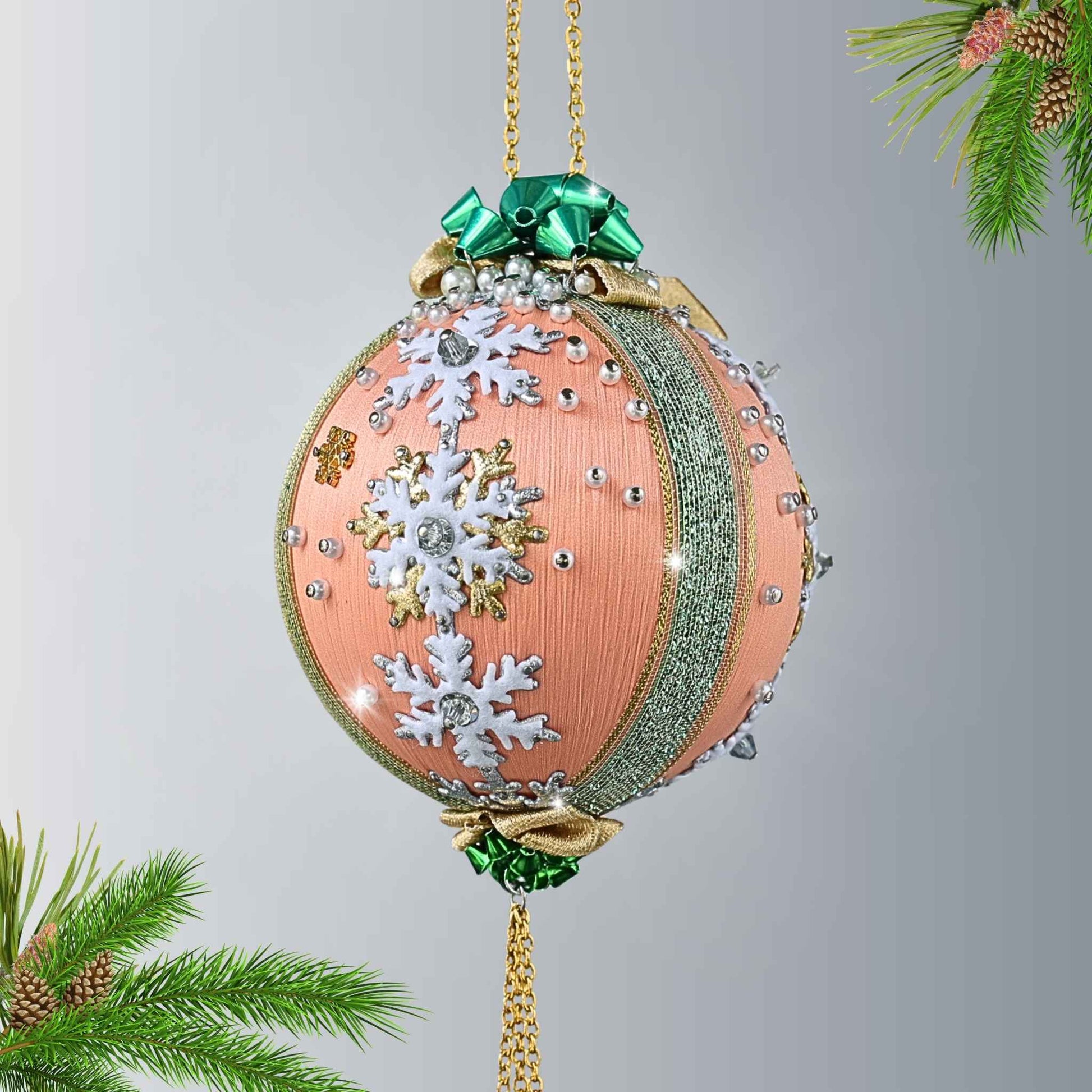 Handcrafted vintage style apricot colored satin push pin ornament with white snowflake trims, gold chains, and pearl beads, hanging on a gold chain by Whim5seasons.