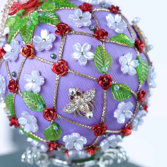 A close-up detail showcasing Whim5seasons' crafting - delicate pearly flowers and a gold bee pinned to a satin foam core.