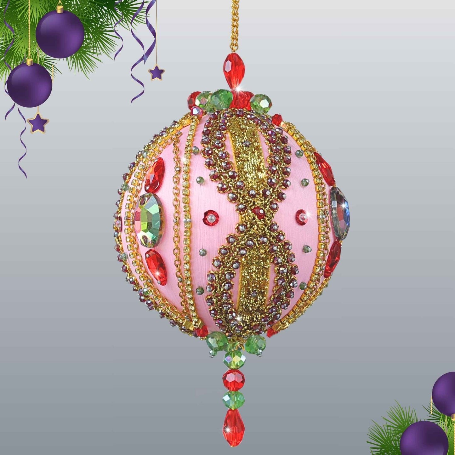 No sew handmade Christmas Beaded Ornament Ball in pink embellished with glass rhinestones, hanging on a gold chain in front of a light gray background by Whim5seasons.