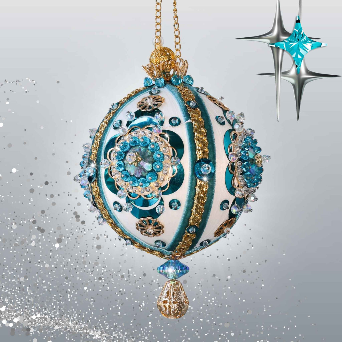 Handmade white satin push pin ornament with large blue crescent sequins, and blue and gold trims, hanging on a chain in front of light gray background by Whim5seasons.