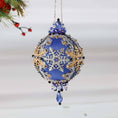 Load image into Gallery viewer, Handmade Christmas Satin Ornament with clear glass beads, silver snowflake, and a silver chain on a white background with a green holiday branch. (Blue)
