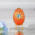 Load image into Gallery viewer, A handmade large Easter egg push pin ornament with a large gold flower on a gold stand on a reflective surface.
