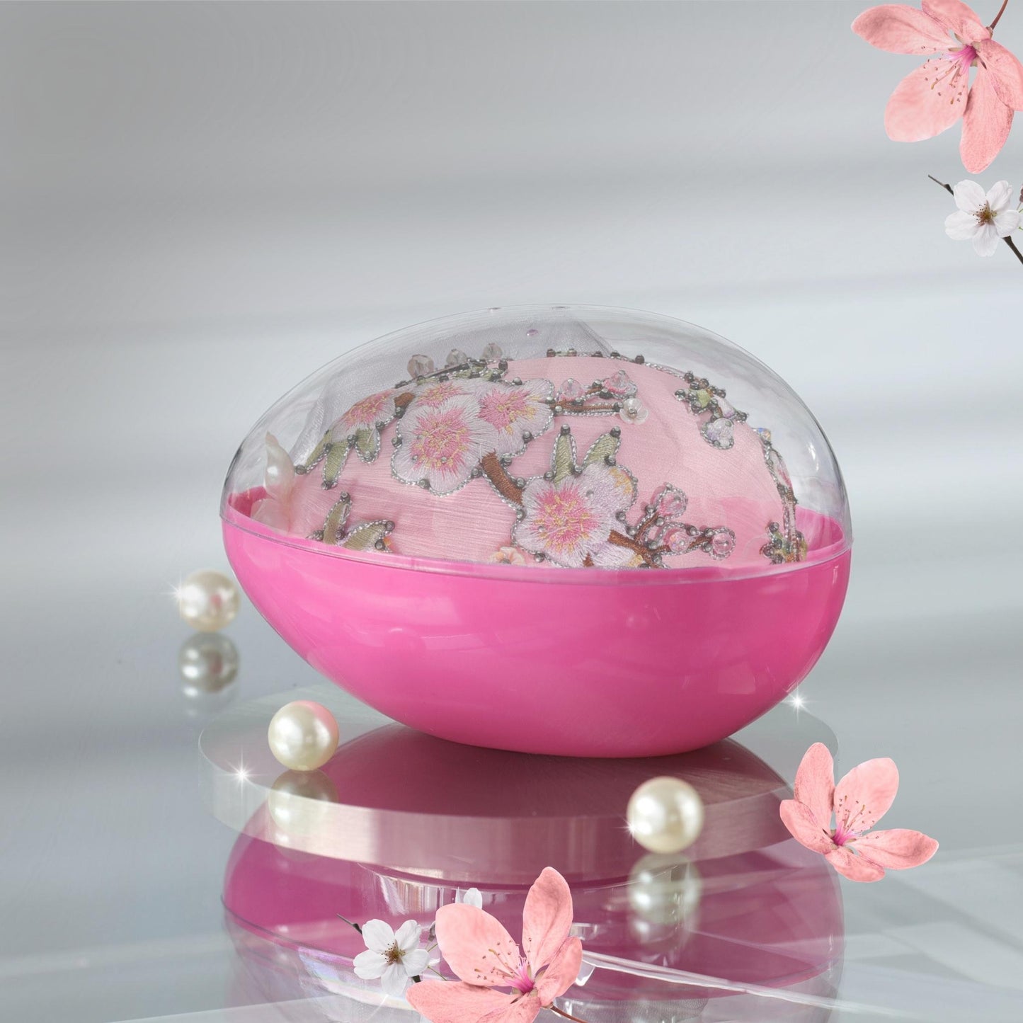 Handmade Easter Egg Satin Push Pin Ornament  by Whim5seasons packed in organza bag and a pink container with a clear lid on a reflective surface.