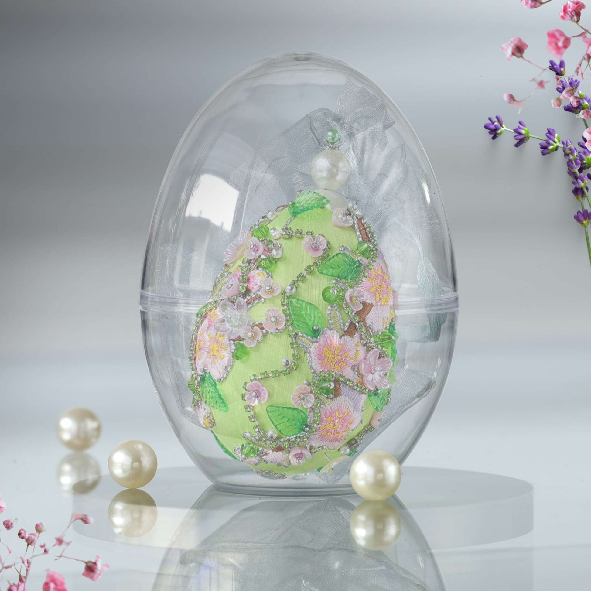 Handmade Easter Egg Push Pin Ornament in a see-through elegant organza bag with a large gold egg-shaped container in the background by Whim5seasons.