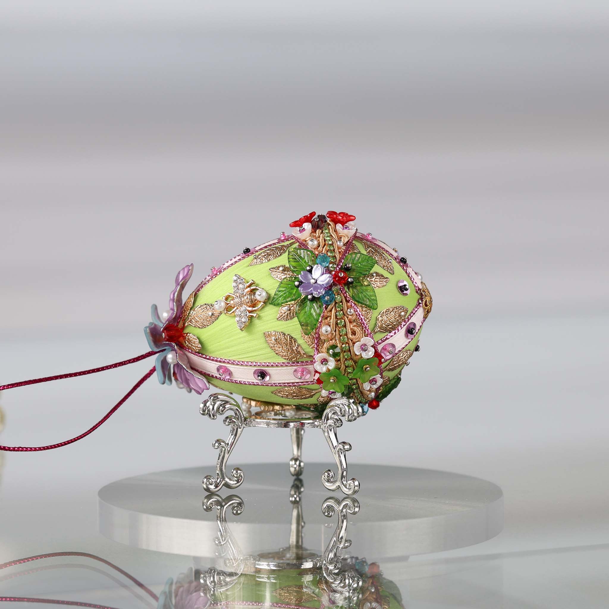 Handmade Easter Push Pin Ornament embellished with crystals, beads, and metallic trim on a silver stand against a light gray background by Whim5seasons. 