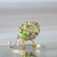 Load image into Gallery viewer, Close up of a handmade Easter Egg Push Pin Ornament embellished with crystals, beads, and metallic trim on a gray background with large pearls by Whim5seasons. 
