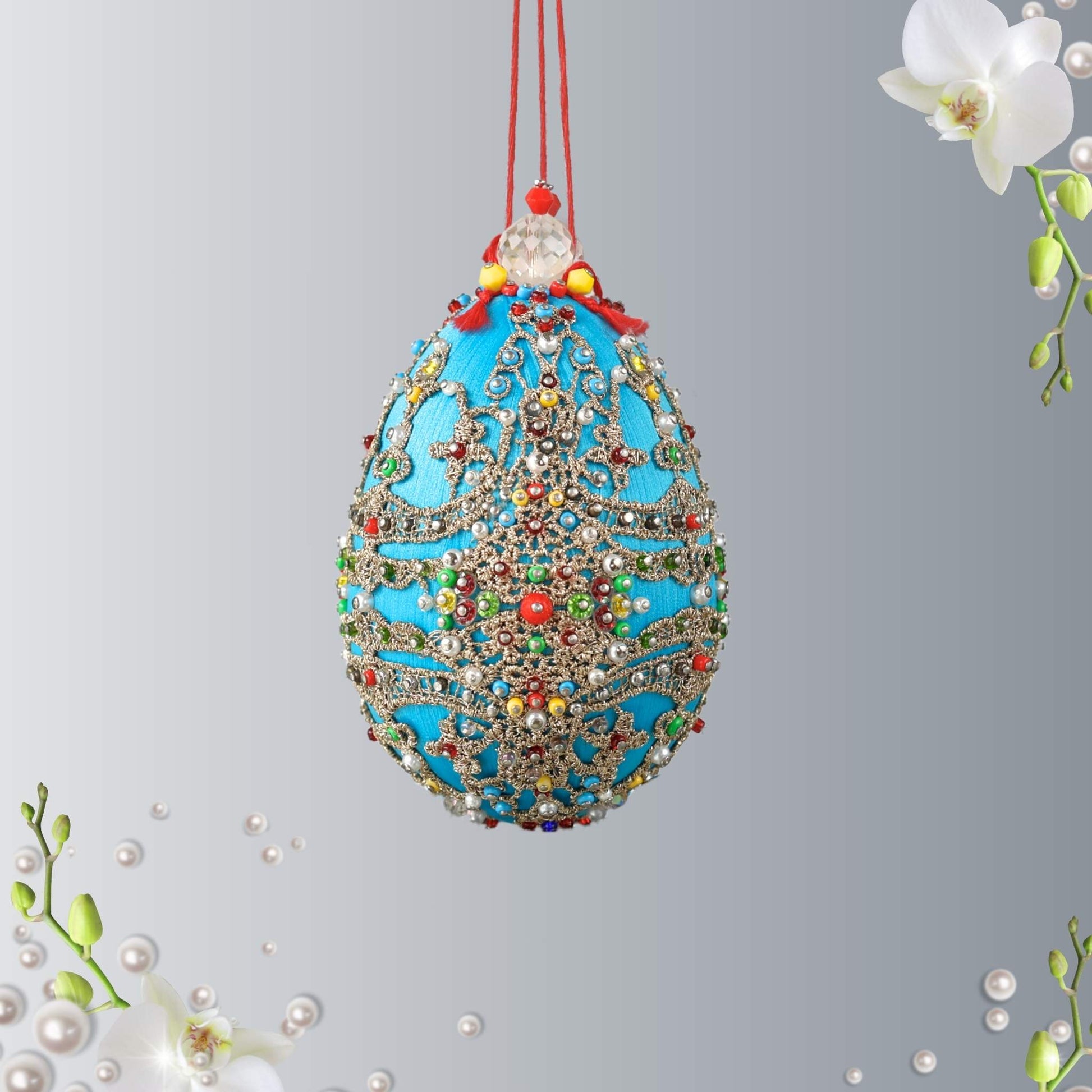 Handmade Easter Egg Ornament was completed by push pin method using premium  satin  sky blue egg shaped core, beads, embellishments, and metallic trim by Whim5seasons.