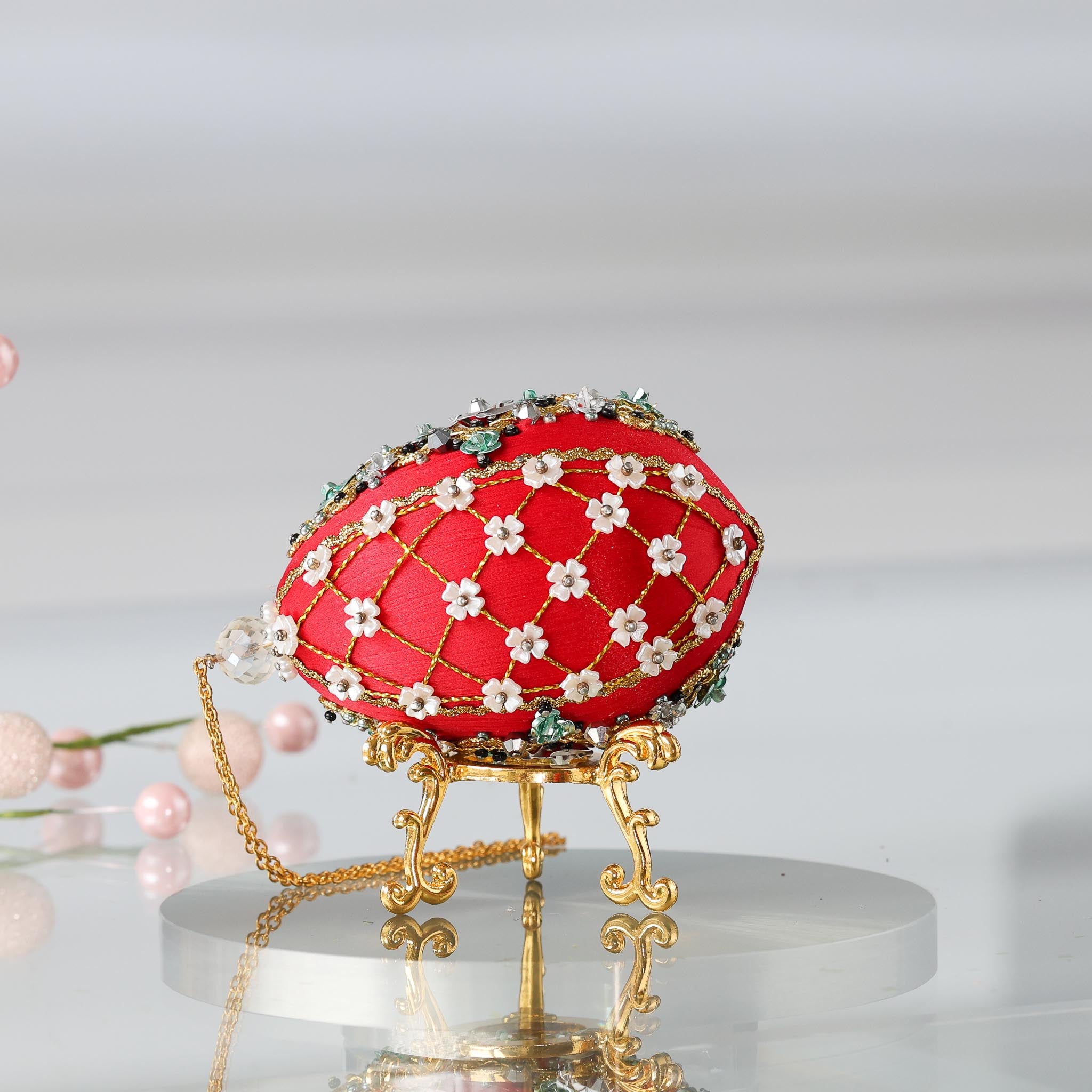 Handmade Easter Push Pin Ornament embellished with crystals, beads, and metallic trim on a gold stand against a light gray background. (Dark Red).