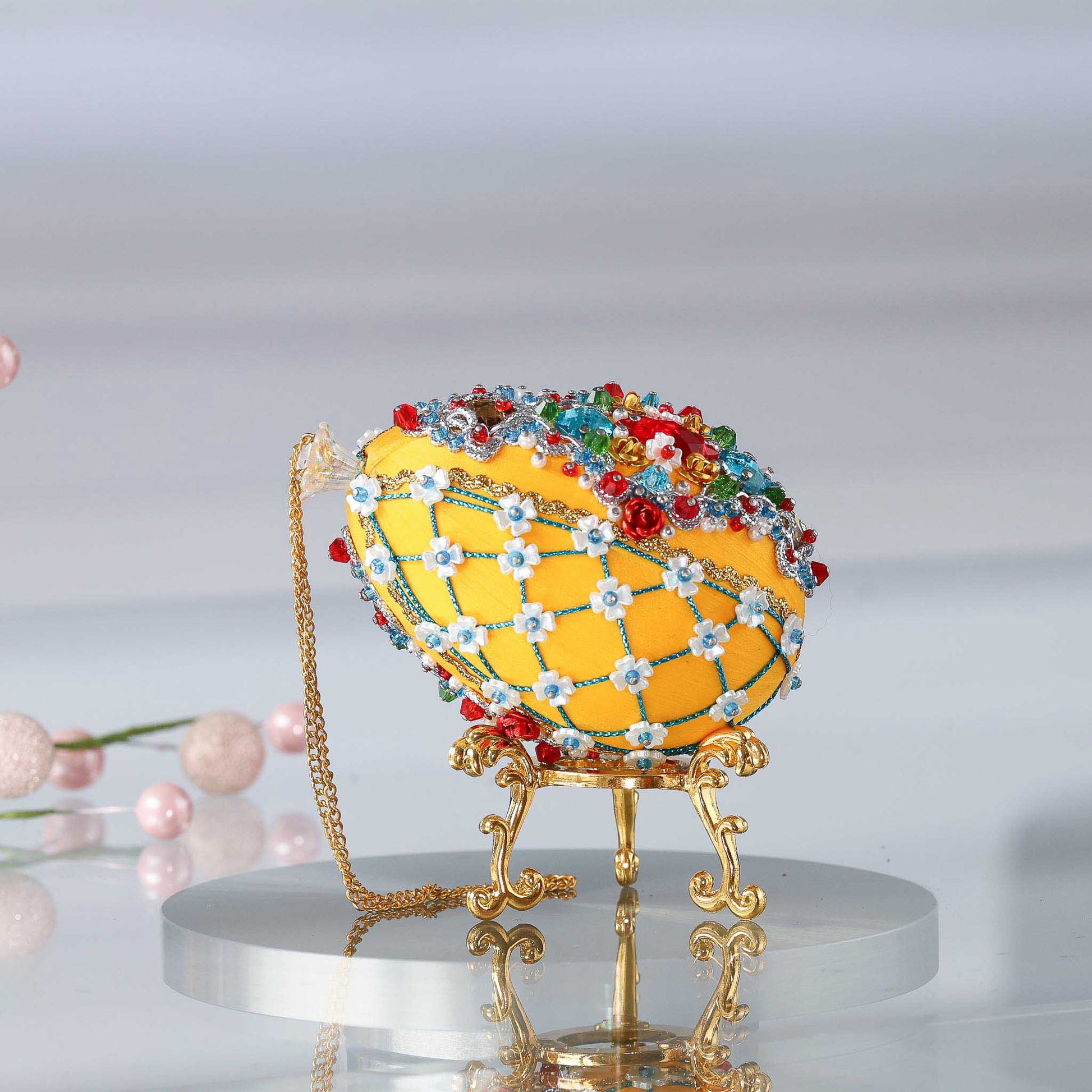 Handmade Easter Push Pin Ornament embellished with red aluminum roses, green leaf charms, and metallic trim on a gold stand with a gold chain loop by Whim5seasons. (Dark Orange)