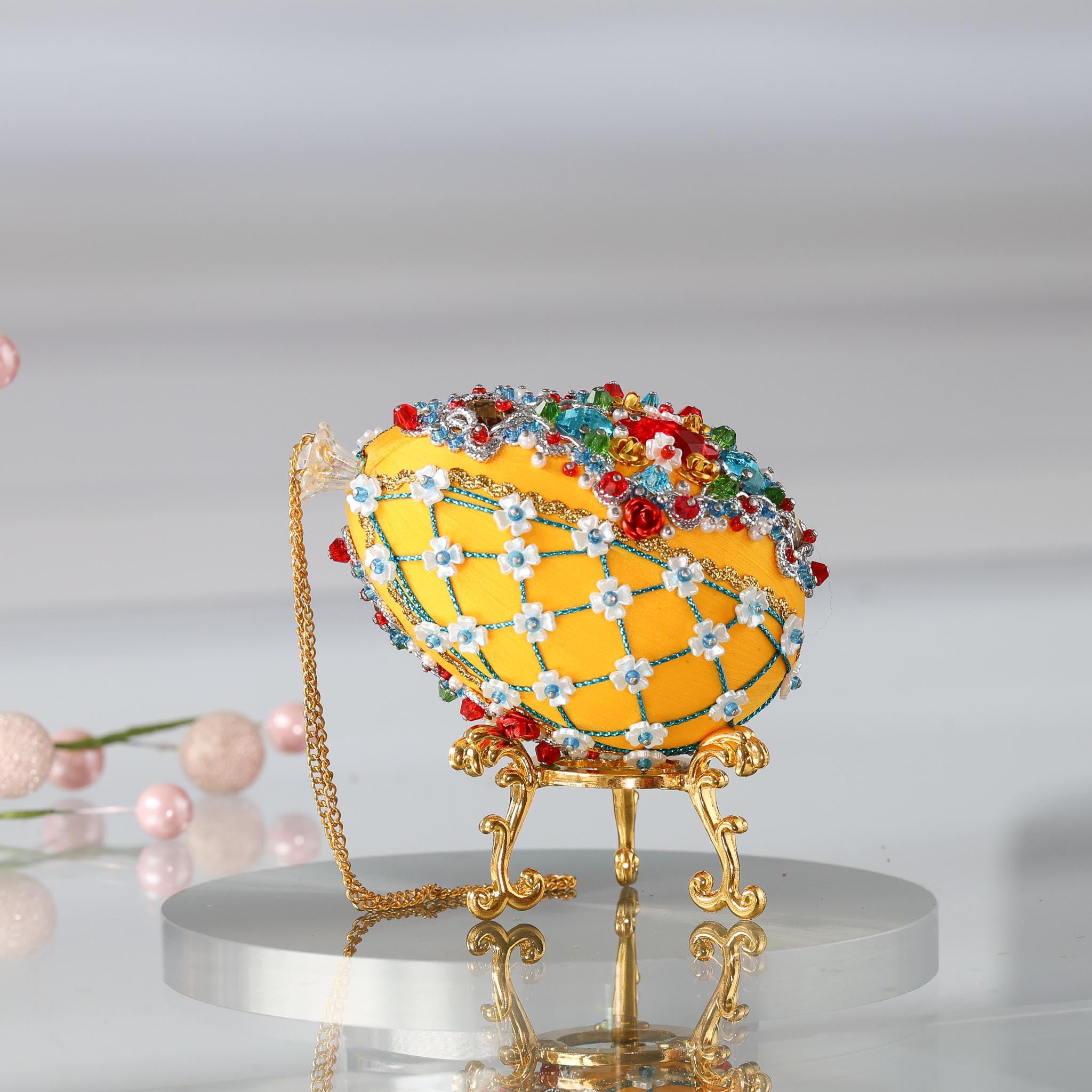 Handmade Easter Push Pin Ornament embellished with red aluminum roses, green leaf charms, and metallic trim on a gold stand with a gold chain loop. (Dark Orange)