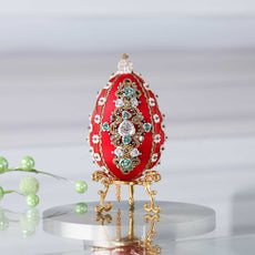 Luxurious handmade push pin Easter Egg in red on a gold stand set against a light background featuring gold, deep red, and silver colors. (Dark Red)