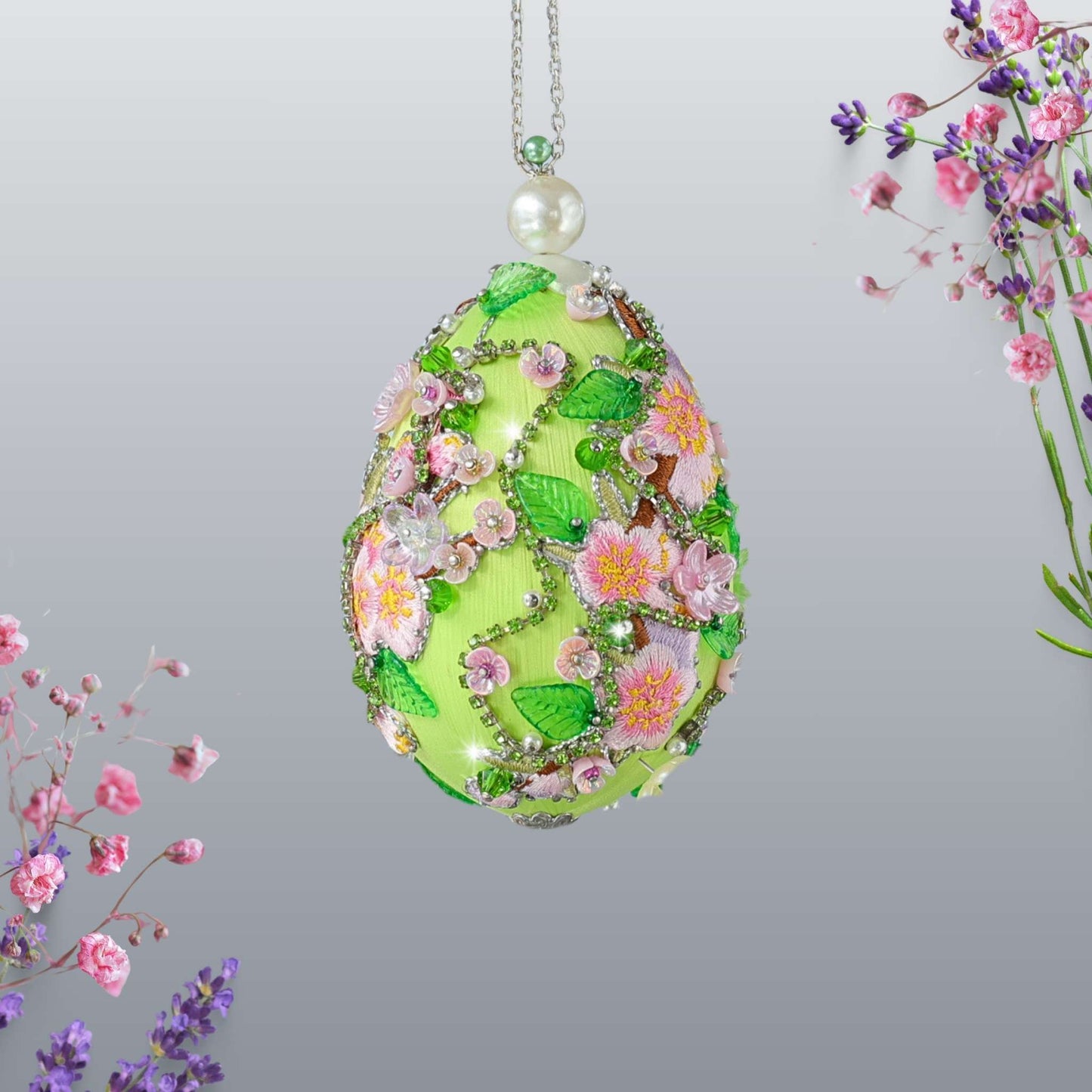 Luxurious handmade push pin Easter Egg on a gold stand with large pearls set against a light background featuring gold, pink, and green colors Whim5seasons.