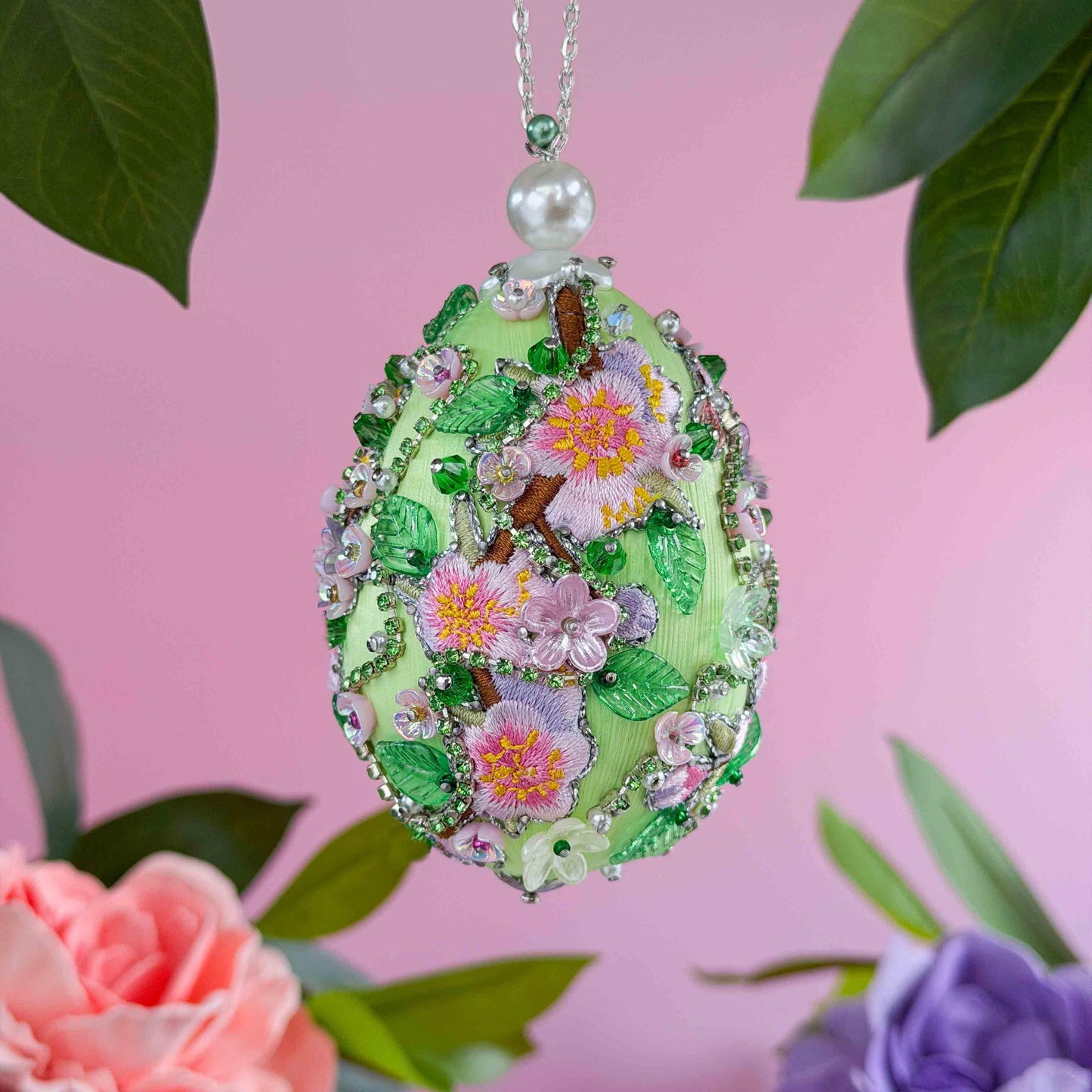Decorative Easter egg ornament with floral design and green leaves featuring acrylic charms pinned by hand to a satin foam core by Whim5seasons.