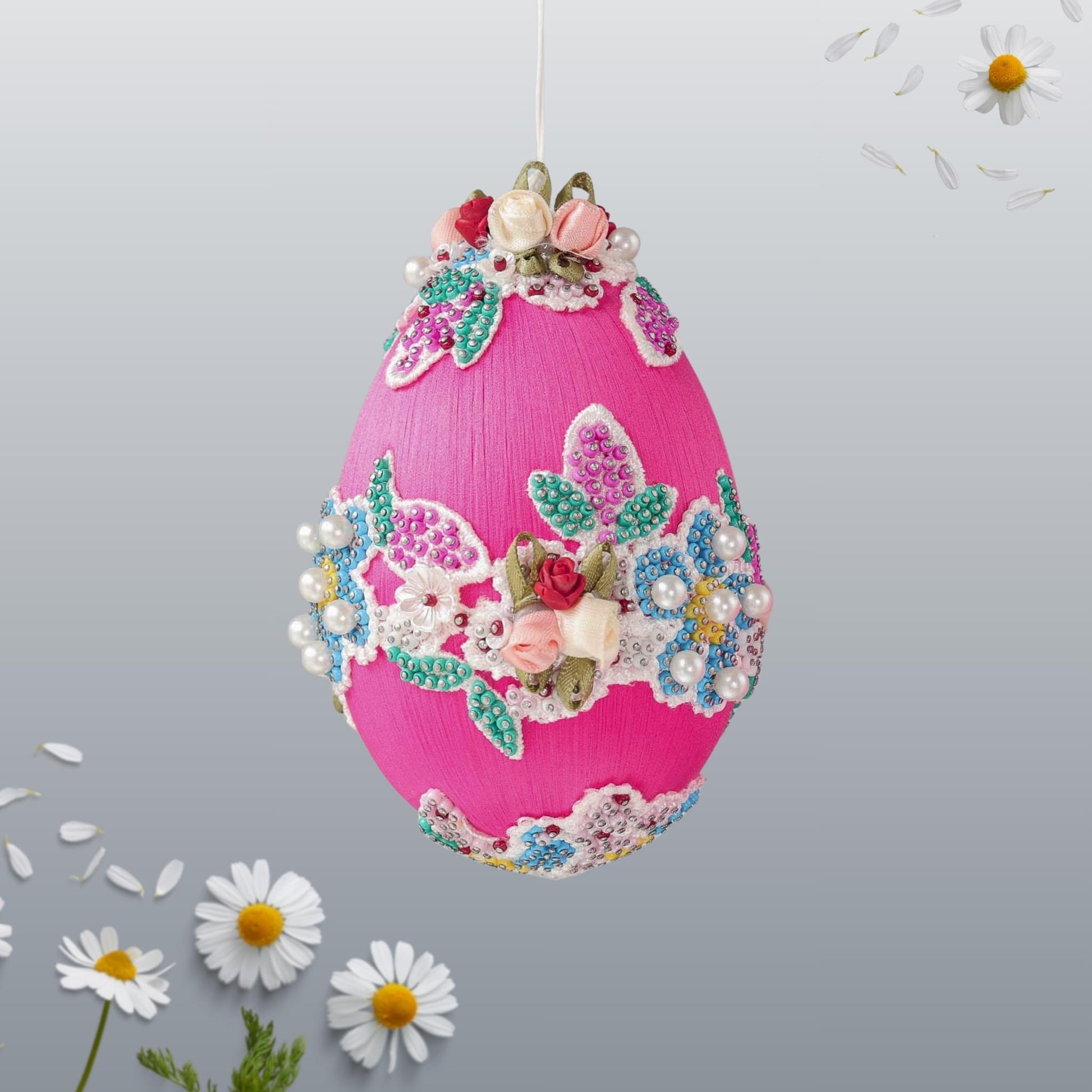 Festive pink handmade beaded Push Pin Easter egg ornament handmade using seed beads and hundreds of dressmaker pins with floral lace on a gray background by Whim5seasons.