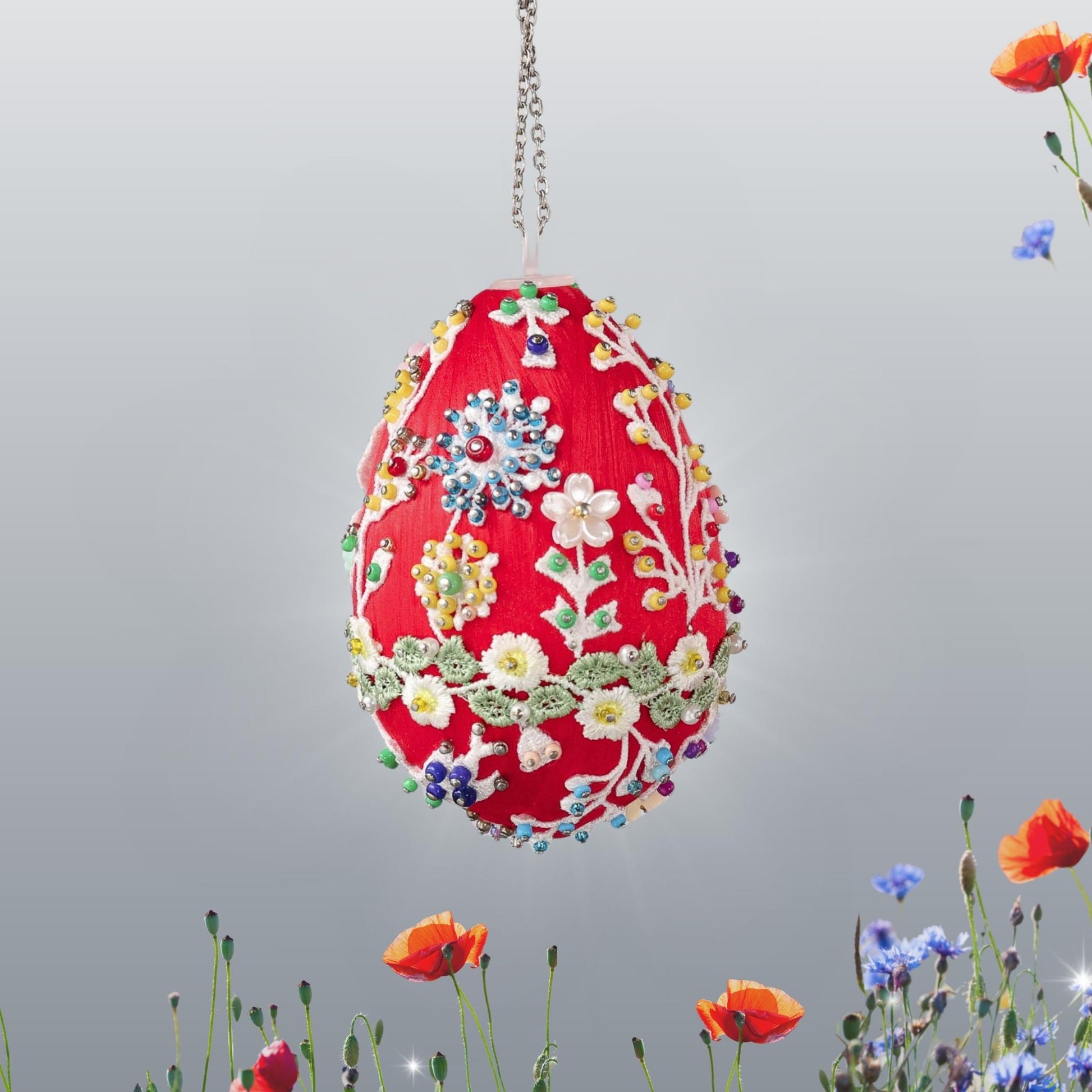 Small red Easter egg push pin ornament with white floral patterns embellished with multicolor beads hanging on a chain by Whim5seasons.