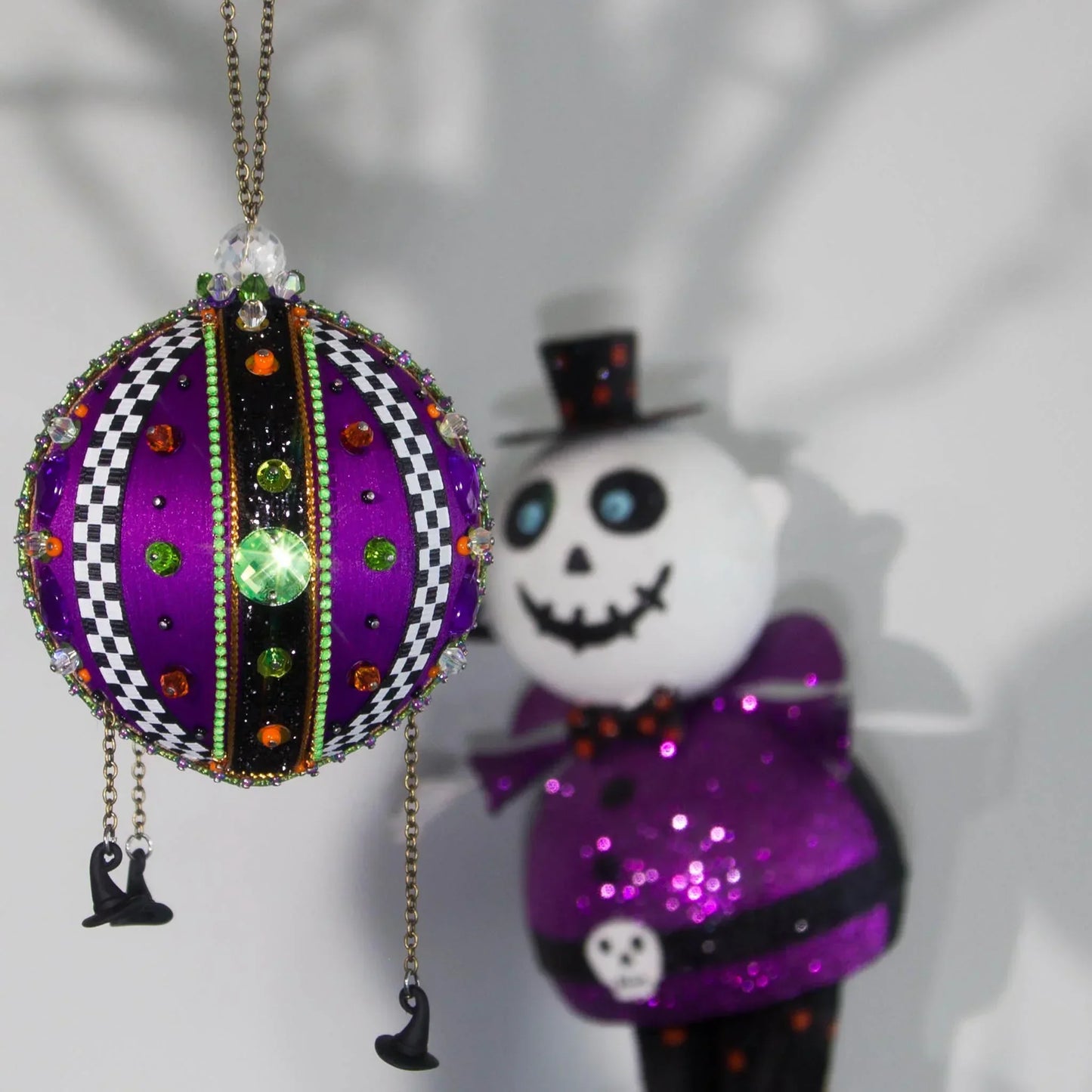 Bright purple Halloween handmade satin ornament with a scary statuette in a background by Whim5seasons.