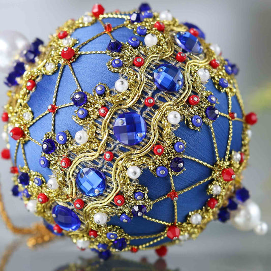 Close-up detail of a handmade push pin ornament - dark blue satin foam ball with indigo rhinestones, gold accents, seed beads, and pearls. (Dark Slate Blue)