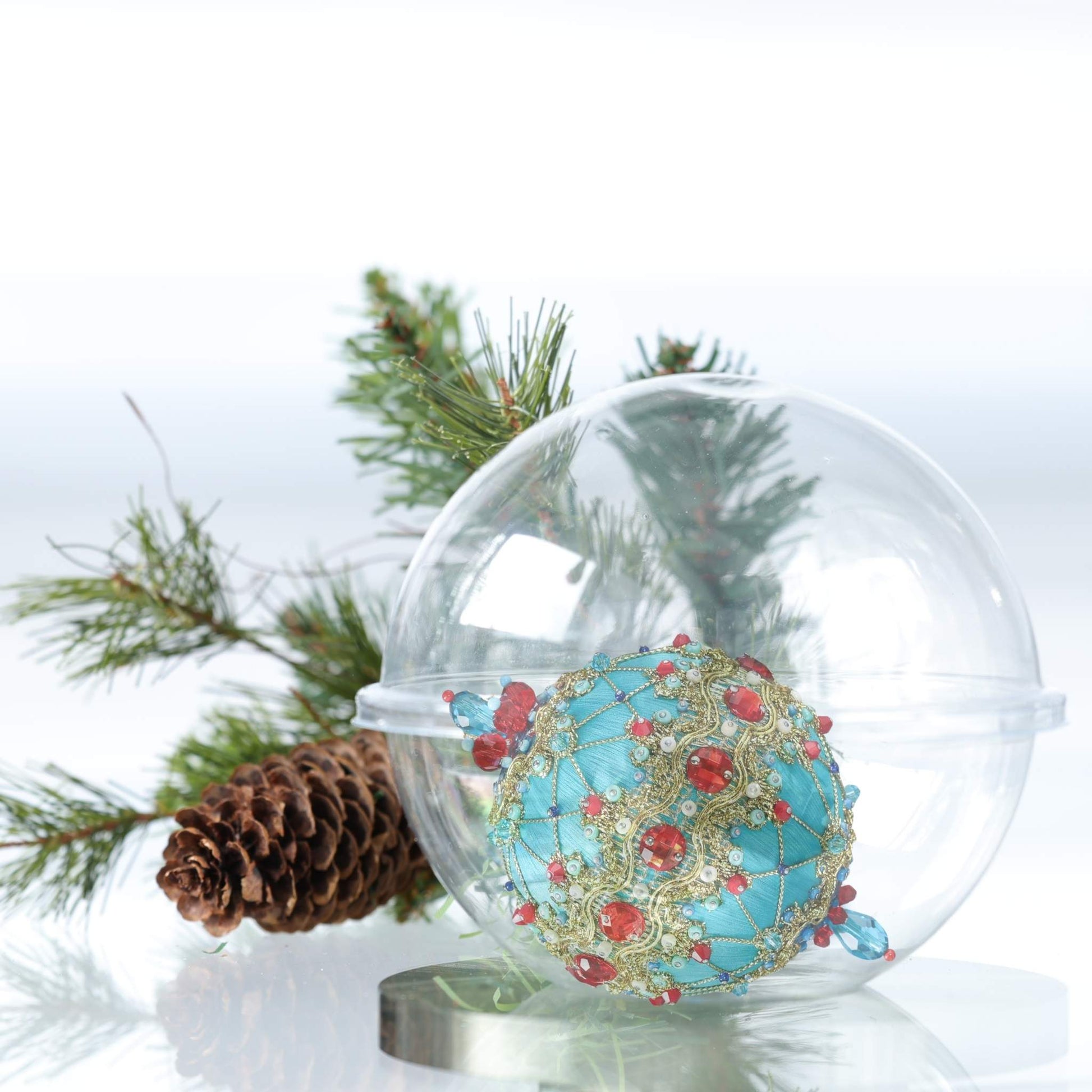 Christmas handmade push pin ornament in a handy clear round container for storage on a light gray background with a red decoration.(LightSeaGreen)