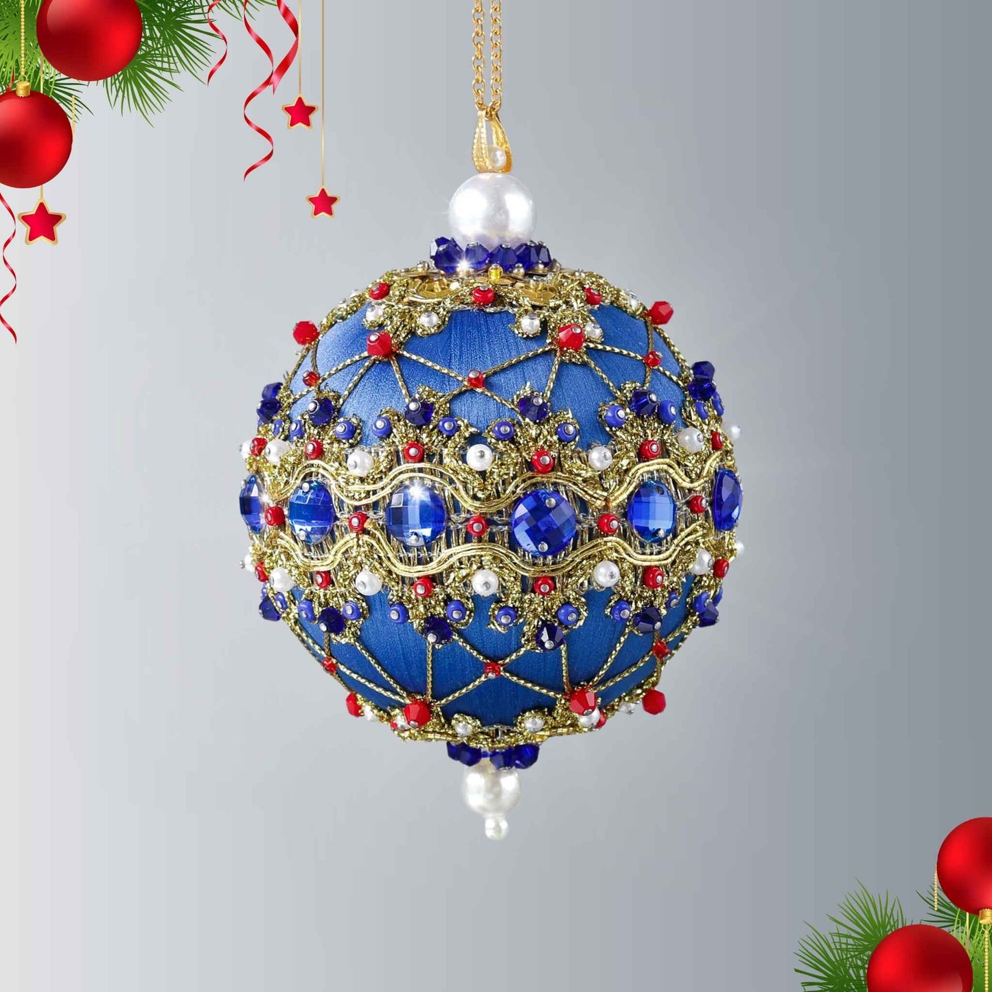Handmade push pin ornament hanging on a gold chain. Festive blue satin foam ball with indigo rhinestones, sparkling gold trim, sequins, red bicone beads, and metallic cord by Whim5seasons.