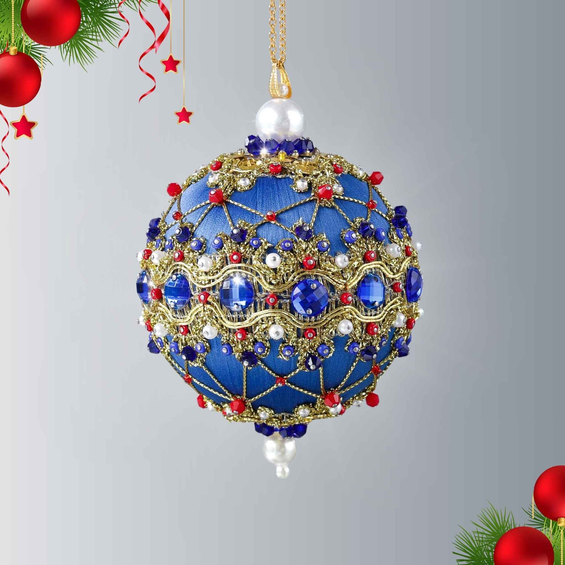 Handmade push pin ornament hanging on a gold chain. Festive blue satin foam ball with indigo rhinestones, sparkling gold trim, sequins, red bicone beads, and metallic cord by Whim5seasons.