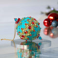 Load image into Gallery viewer, Close-up Detail of Scheherazade Handmade push pin ornament - teal-colored ball with red rhinestones, blue accents, sequins, seed beads, gold chain, and metallic cord. (Light Sea Green)
