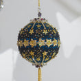 Load image into Gallery viewer, A close-up of a handmade New Year Star Ornament from Whim5seasons. It features sparkling rhinestones, and gold accents set on a rich fark blue satin ball. (Dark Slate Blue)
