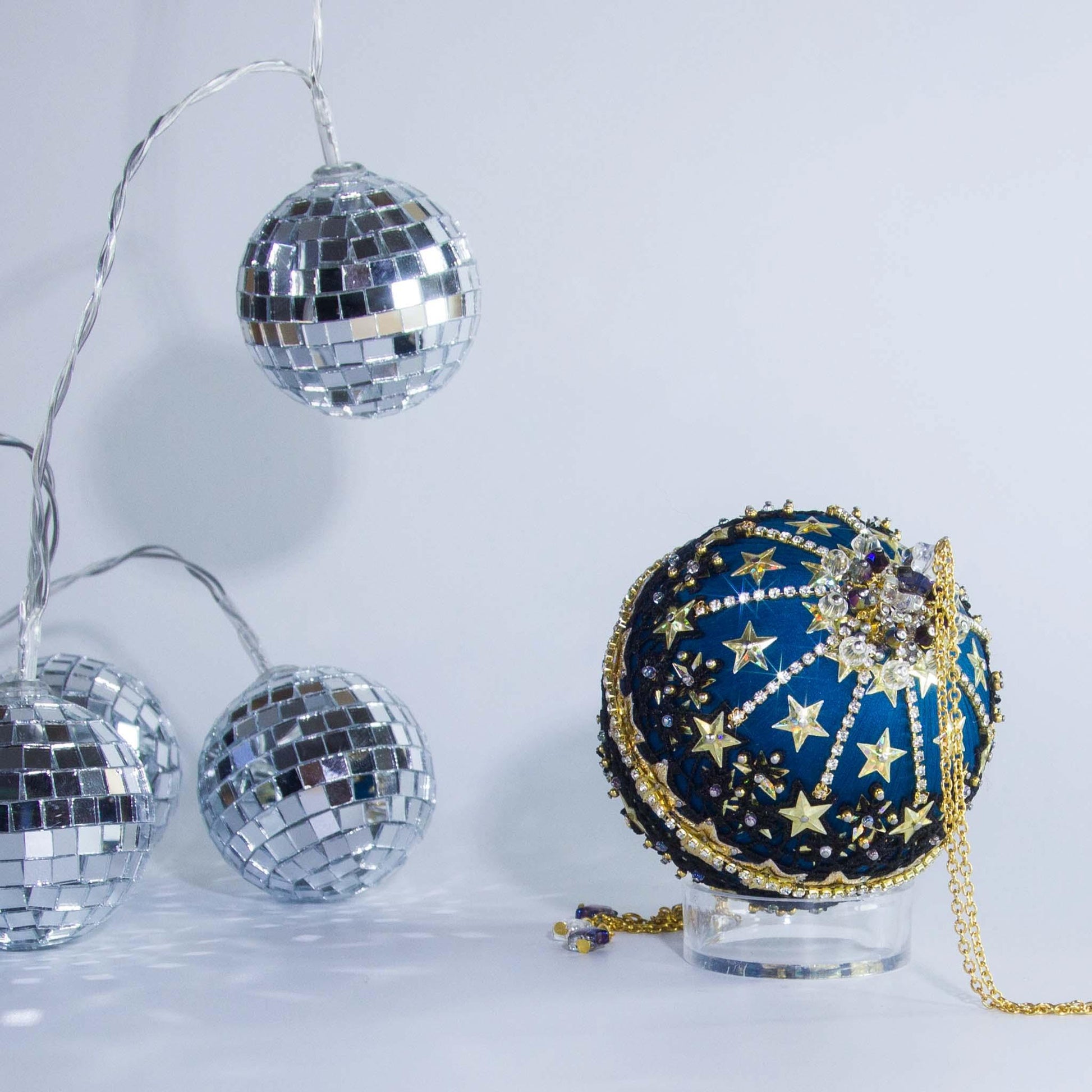 A close view of the bottom detail of New Year Star Ornament from Whim5seasons showcasing sparkling rhinestones, gold sequin stars, and crystal beads. (Dark Slate Blue)