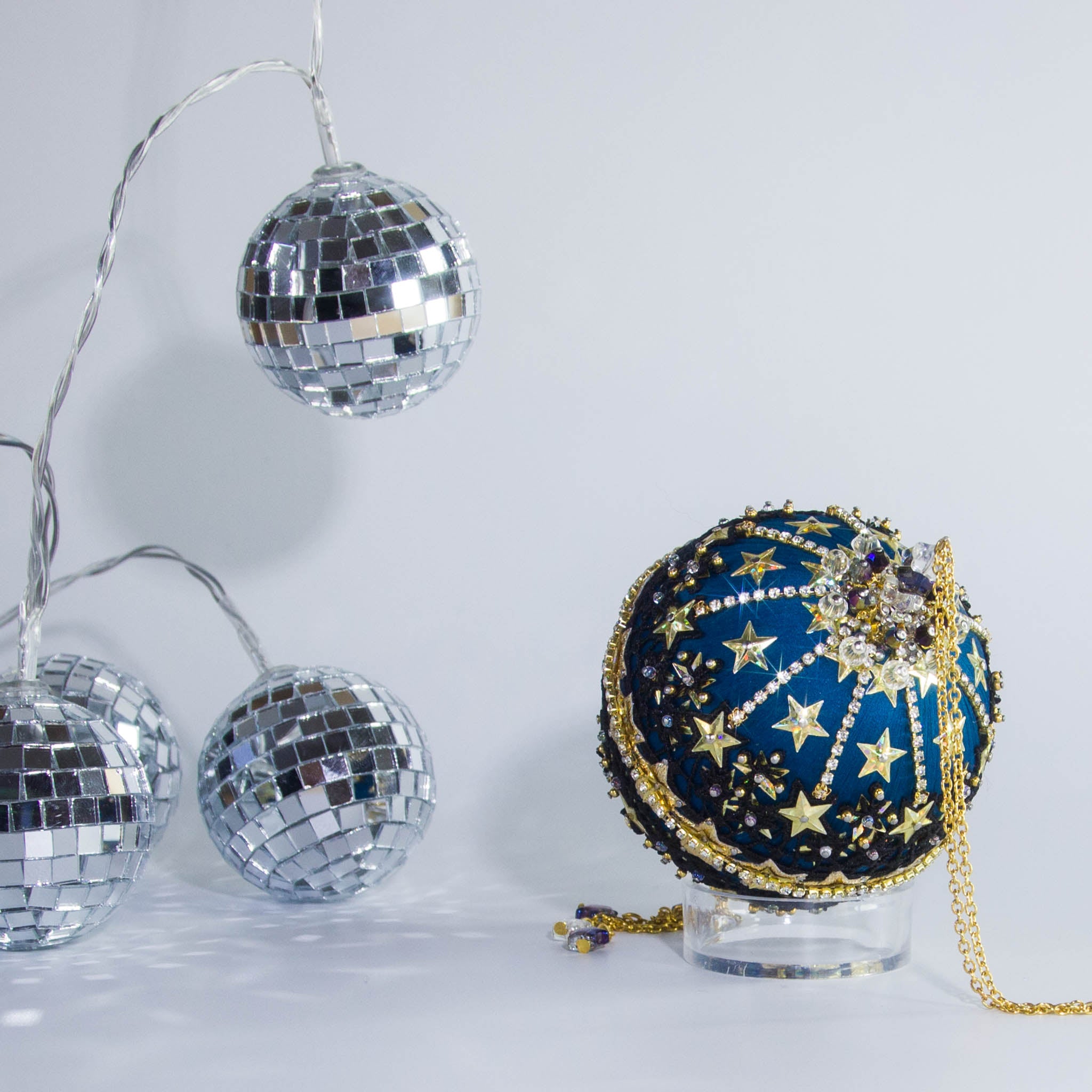 A close view of the bottom detail of New Year Star Ornament from Whim5seasons showcasing sparkling rhinestones, gold sequin stars, and crystal beads. (Dark Slate Blue)