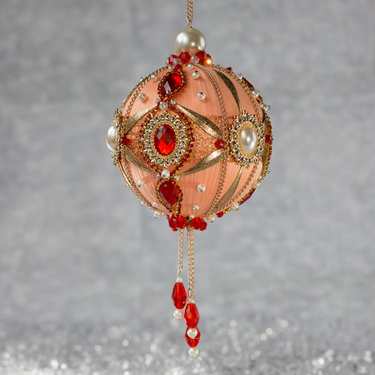Phoenix Christmas Beaded Handmade Satin Ornament features large cameos with bright red rhinestones, beautifully contrasted against the peachy satin ornament. (Coral)