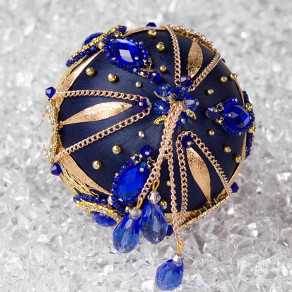 Close-up of Phoenix Christmas  Handmade Push Pin Ornament embellished with gold cameos, intense blue rhinestones, metal accents, and rose old chain. (Navy)