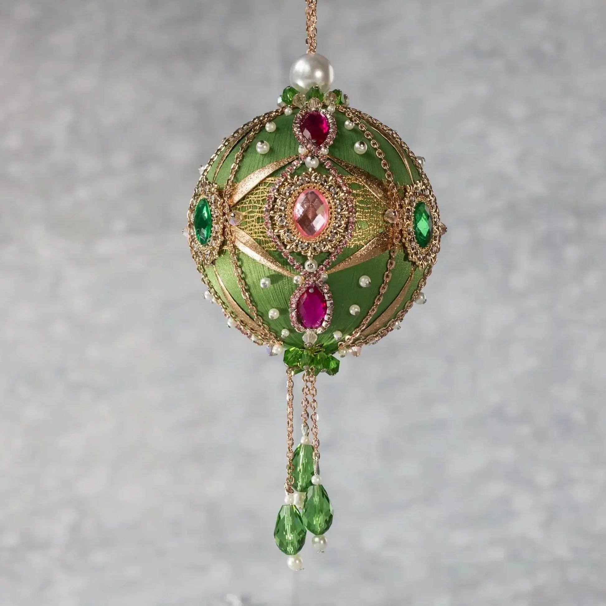 Side view of Phoenix Christmas Handmade Satin Ornament features large cameos with pink and green rhinestones, gold alloy accents, and gold chain. (Olive)