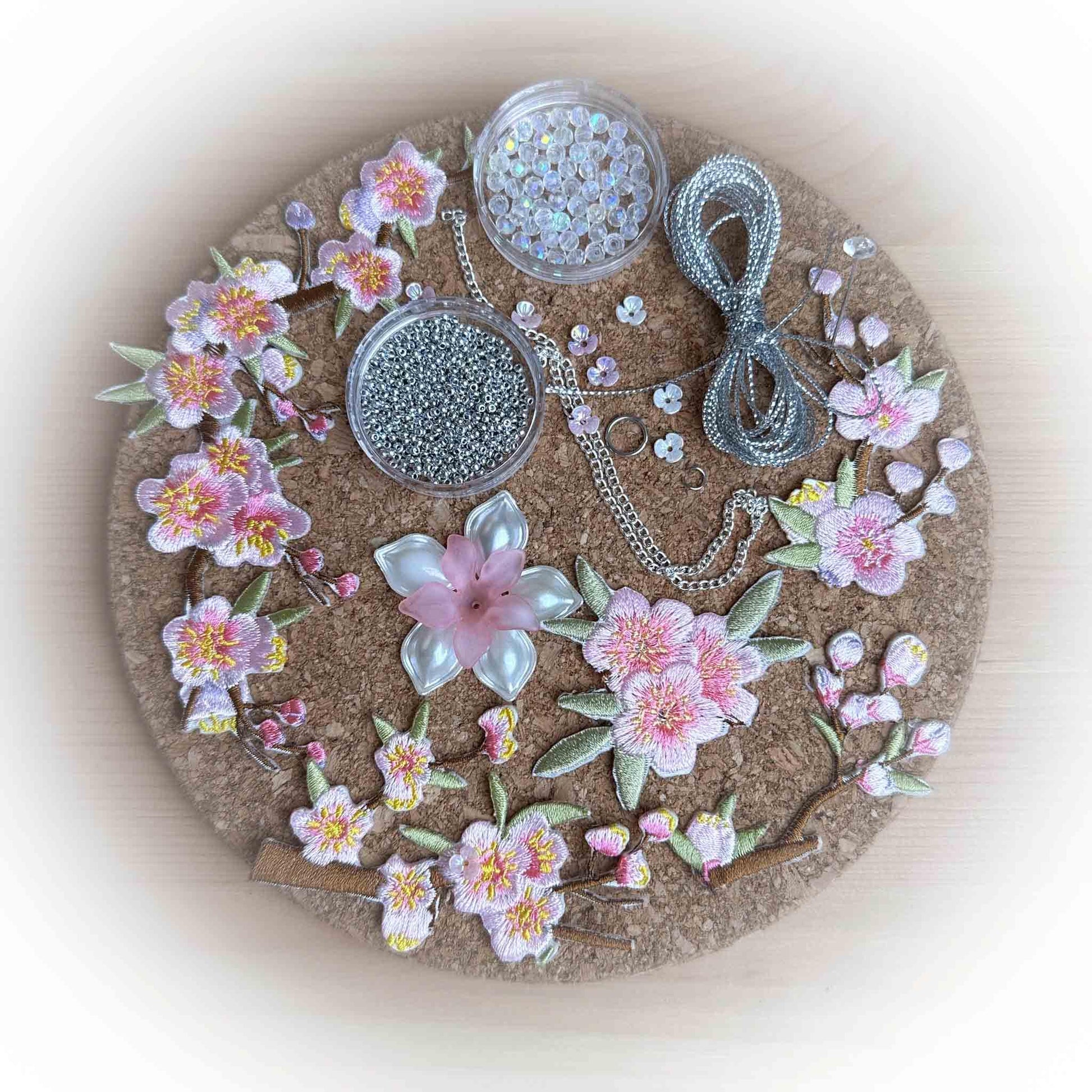 Silent Glamour Satin Easter Egg Kit includes: embroidered plum blossom patches, silver beads, metallic cord, and other embellishments.