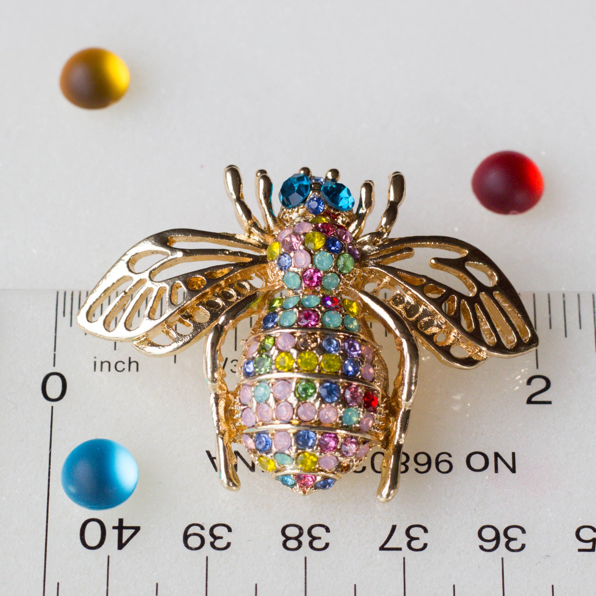 Bee brooch with a ruler, approximately 2" by 2". Versatile embellishment for a garment, handbag, or a large ornament from Whim5seasons.