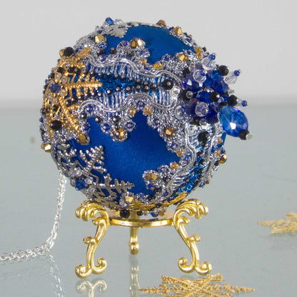 Handmade dark blue bespoke beaded Christmas ornament on a gold stand. (Blue)